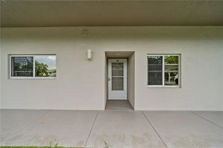 View of exterior entry featuring stucco siding