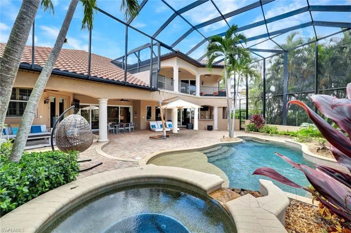 View of swimming pool featuring an in ground hot tub, a patio, ceiling fan, and glass enclosure