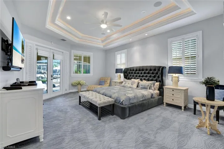 Downstairs Master bedroom with double tray ceilings and access to Lanai.