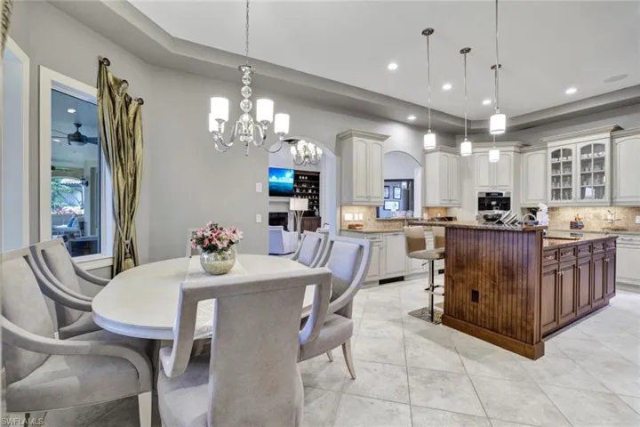 Dining room with an inviting chandelier and light tile patterned floors
