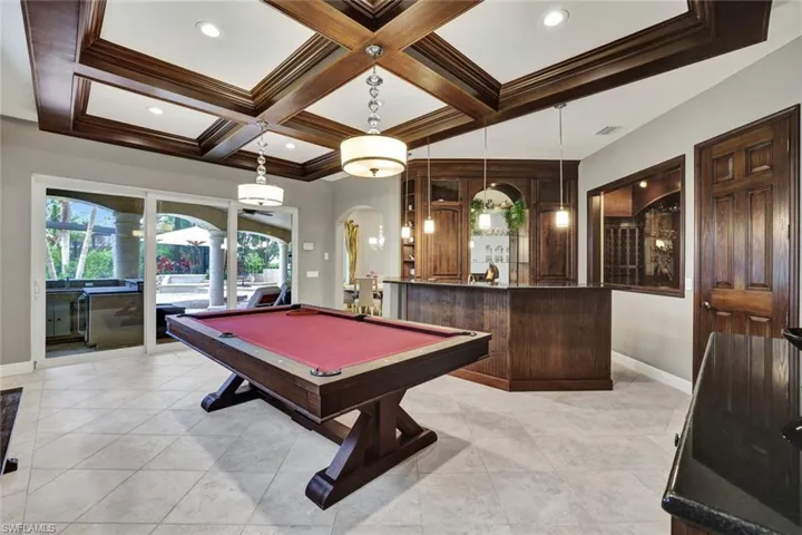 Bonus Room features coffered ceiling, pool table, wet bar with refrigerator, ice maker and climate controlled wine room