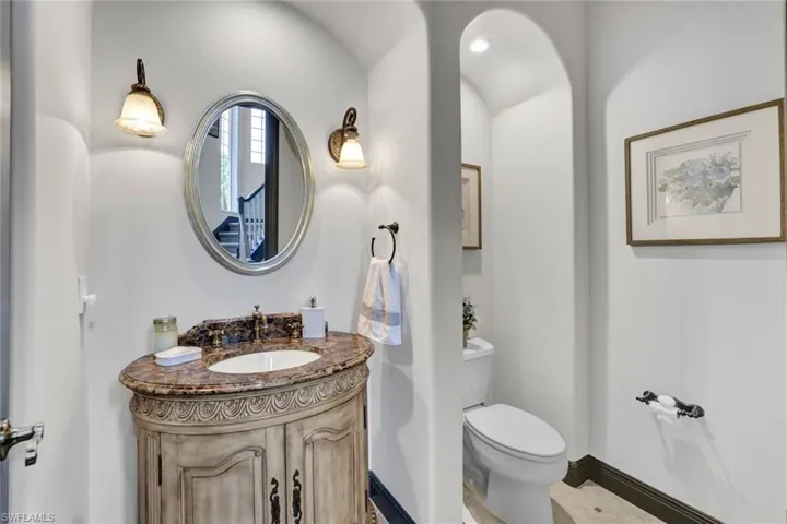 1st floor powder bathroom, located across from staircase.