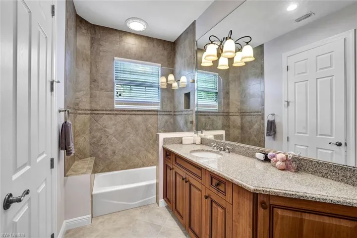 Ensuite Bathroom to the 4th bedroom with single vanity and combination tub and shower