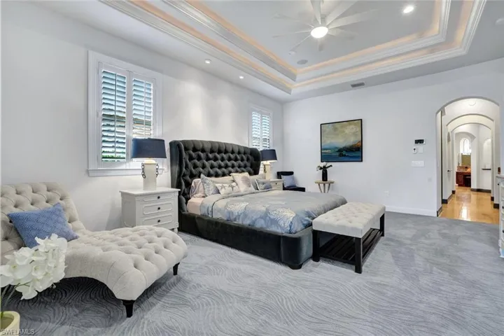 Downstairs Master Bedroom double tray ceilings, hallway leads to Breakfast Bar, spacious walk-in closets and master bathroom.