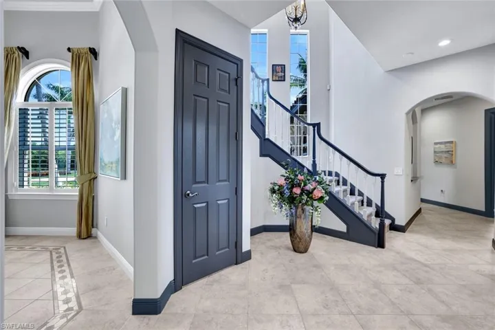 Hallway past formal dining room, pantry door and staircase on left, entry hall to 2nd bedroom on right