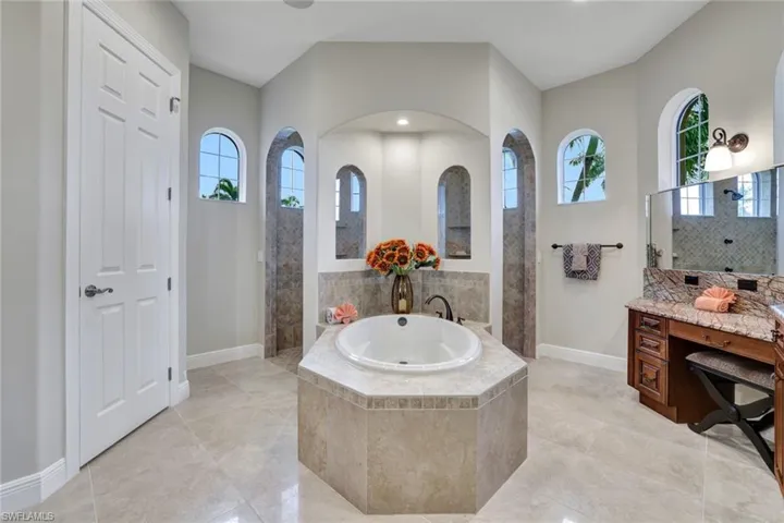 Bathroom featuring separate shower and tub, tile patterned floors, a wealth of natural light, and vanity