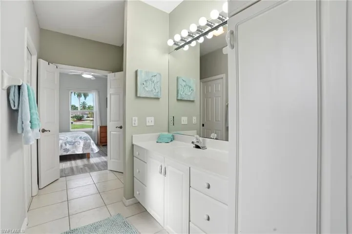Ensuite bathroom featuring vanity and light tile patterned floors