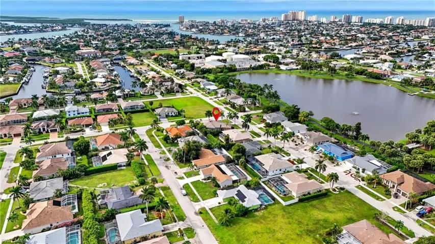 Aerial overview of property's location with a large body of water and nearby suburban area