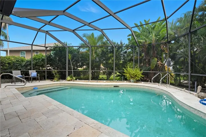 Outdoor pool featuring a lanai and a sunroom
