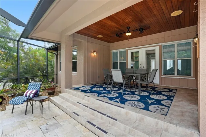 Sunroom / solarium featuring outdoor dining space, a patio area, ceiling fan, and healthy amount of natural light