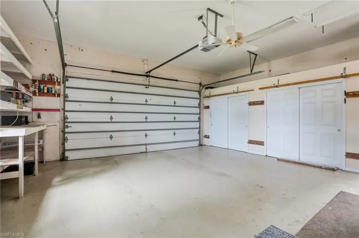 Garage with a ceiling fan and a garage door opener