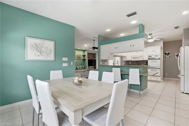 Dining room featuring a ceiling fan, light tile patterned floors, and recessed lighting
