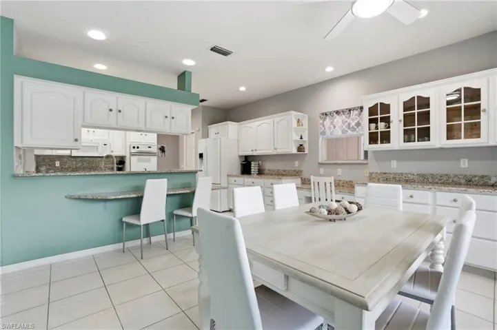 Dining space featuring a ceiling fan, recessed lighting, and light tile patterned floors
