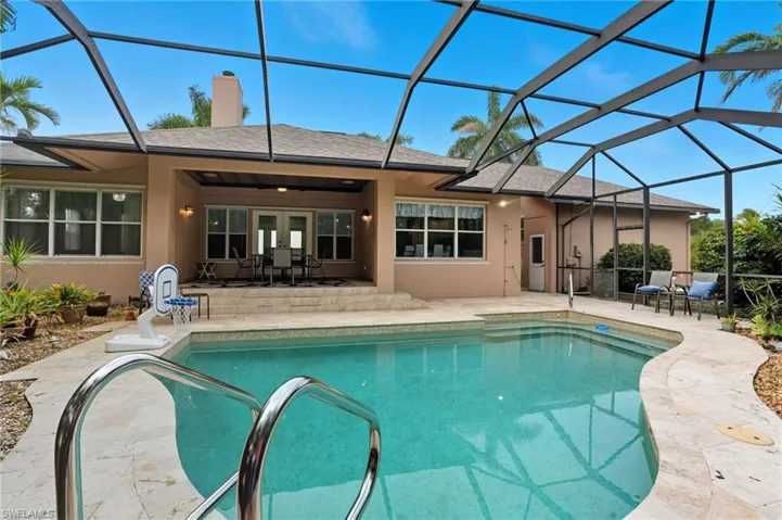 Swimming pool with a sunroom, a patio area, a lanai, and outdoor dining space