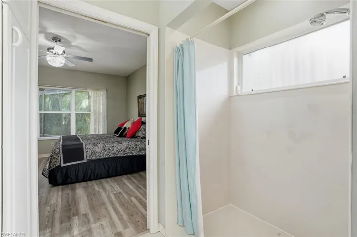 Bedroom with light wood finished floors and ceiling fan