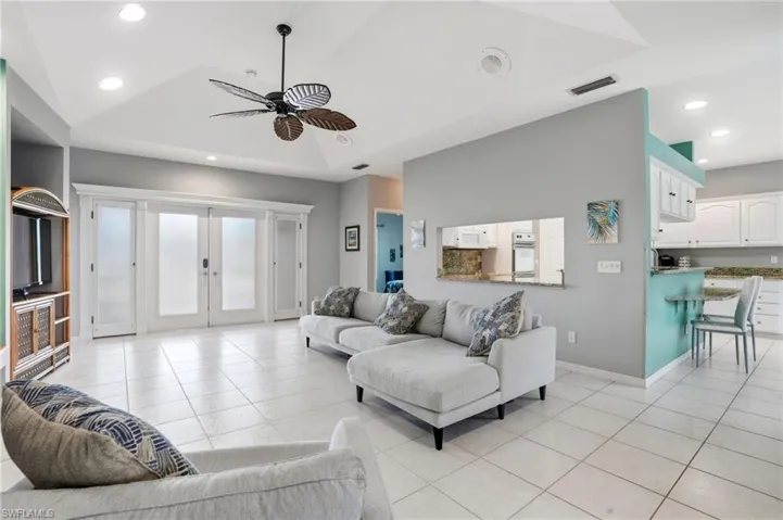 Living room featuring recessed lighting, ceiling fan, french doors, and light tile patterned flooring