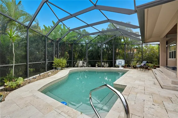 Swimming pool featuring a patio, a lanai, and a sunroom