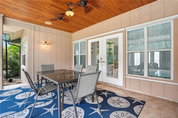 View of patio / terrace with outdoor dining space, a ceiling fan, and french doors