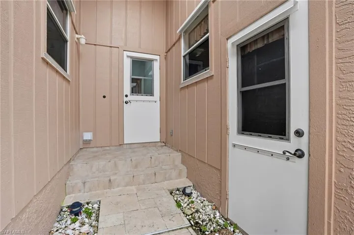 Doorway to property with board and batten siding