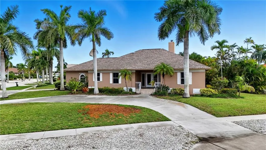 Single story home with a front yard, a chimney, stucco siding, and french doors