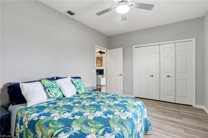 Bedroom featuring light wood-style flooring, a ceiling fan, and a closet