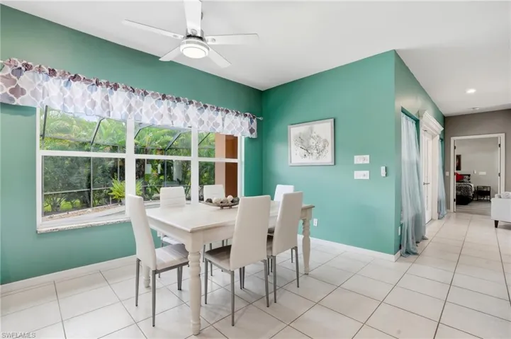 Dining room with a ceiling fan and light tile patterned floors
