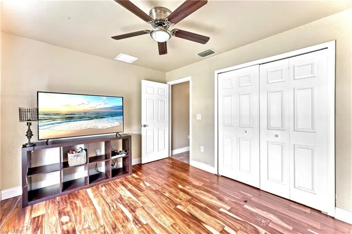 Bedroom featuring wood-type flooring, a closet, and ceiling fan