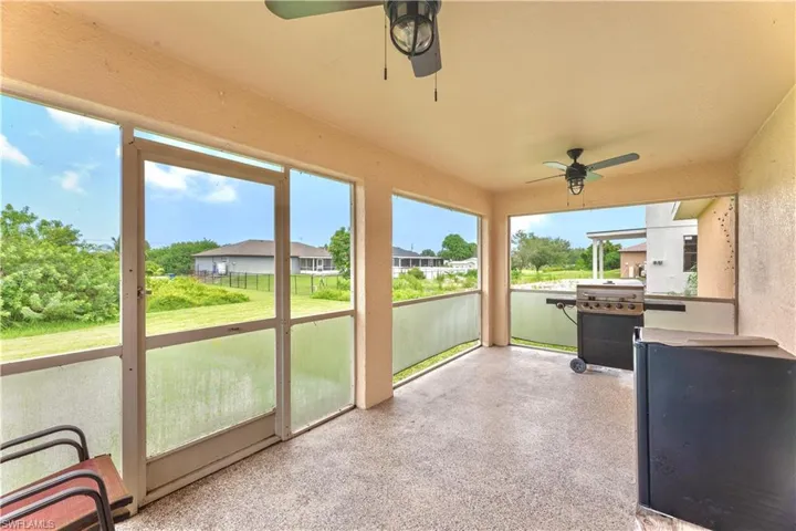 Unfurnished sunroom with ceiling fan