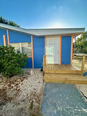 Doorway to property with a deck