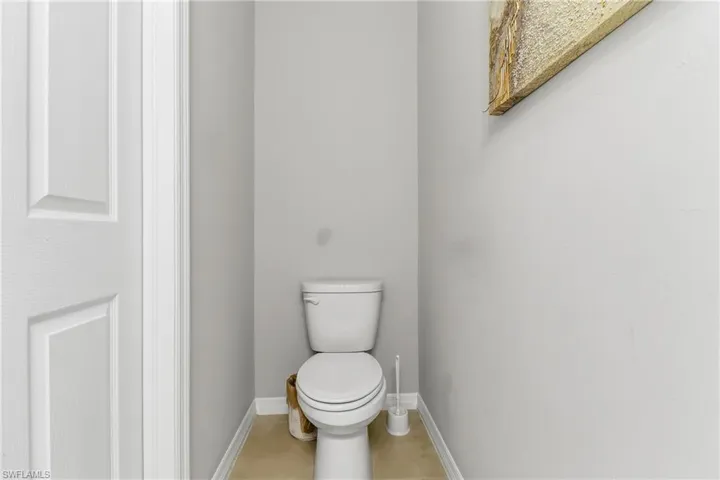 Bathroom with toilet and baseboards