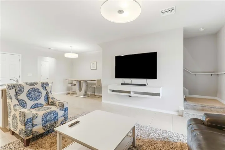 Living area featuring light tile patterned floors and baseboards