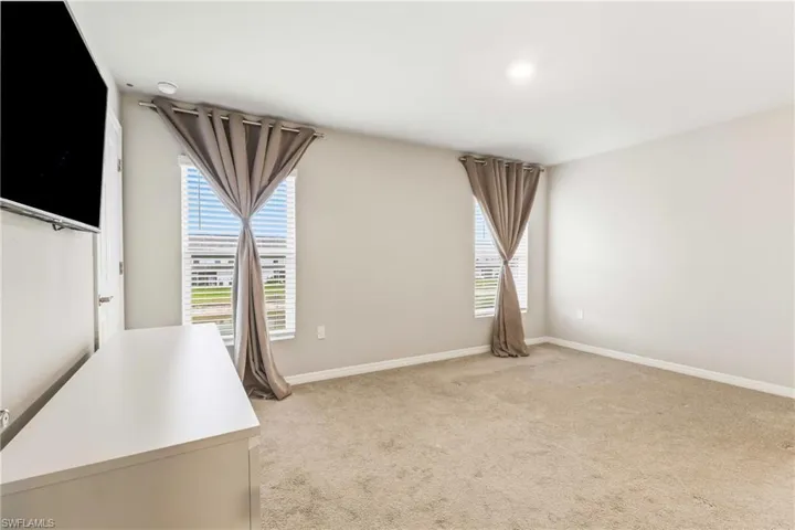 Unfurnished office with light carpet and plenty of natural light