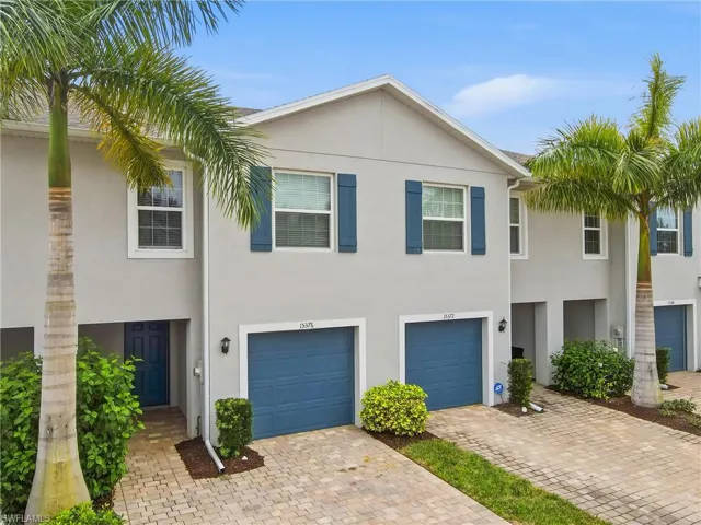 View of front of house featuring stucco siding, decorative driveway, and an attached garage