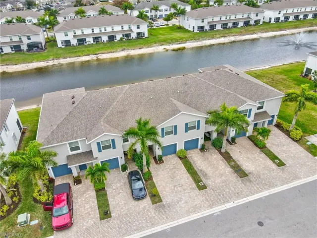 Aerial perspective of suburban area featuring a nearby body of water