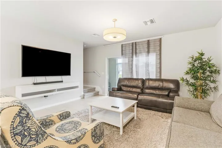 Tiled living area with stairway