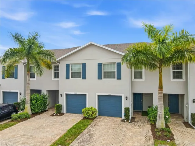 View of front of home with driveway, stucco siding, and an attached garage