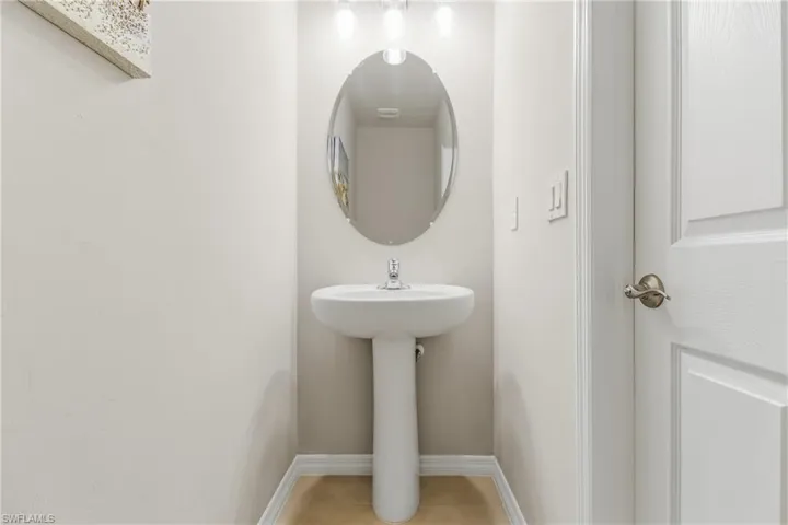 Half bath featuring baseboards