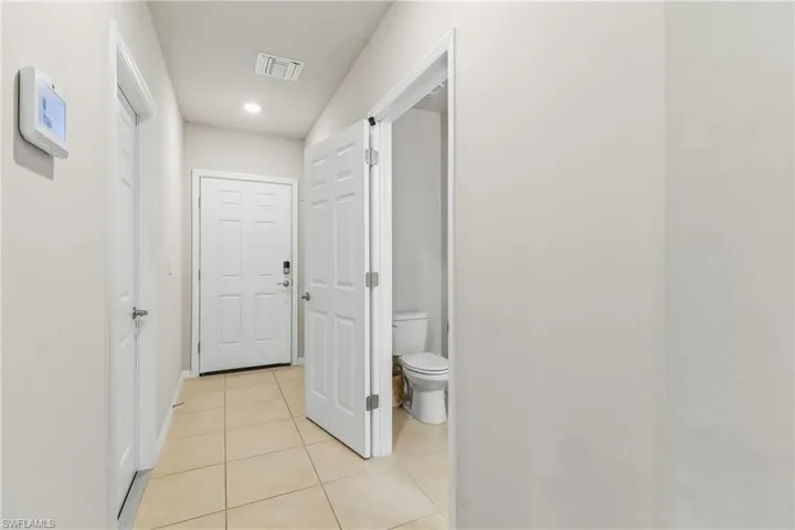 Hallway with light tile patterned floors