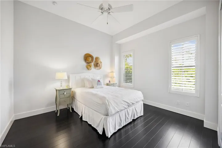 Bedroom with dark wood-style flooring and ceiling fan