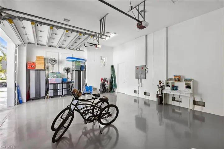 Garage with electric panel and a garage door opener