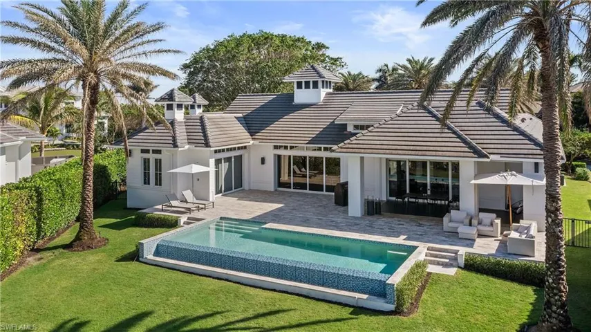 Back of house with a patio area, a tiled roof, and a fenced backyard