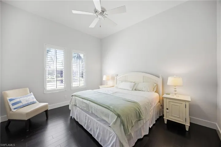 Bedroom with dark wood finished floors and ceiling fan