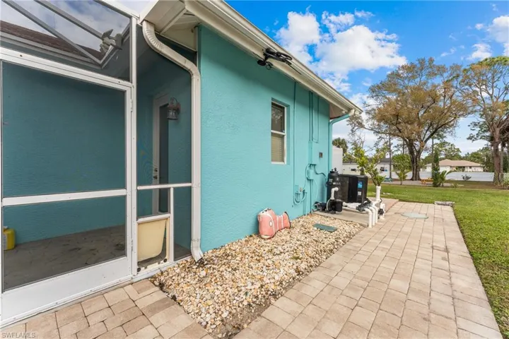 View of side of property featuring a patio area and a yard