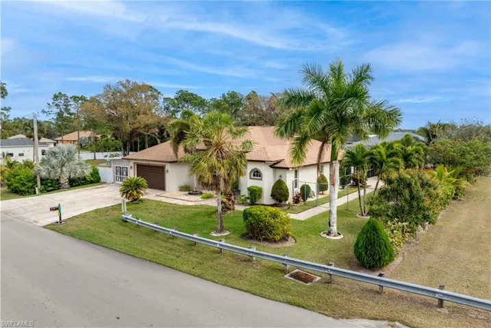 View of front of home with a front lawn and a garage