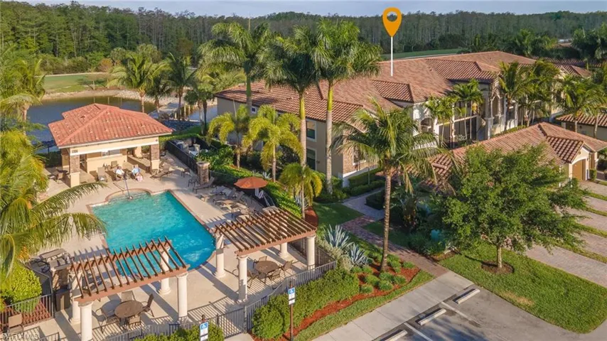 Bird's eye view of a pool area and a nearby body of water