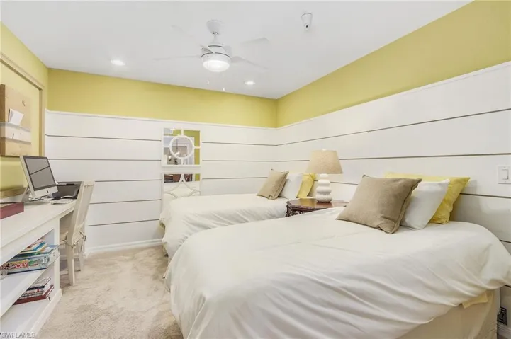Bedroom with light colored carpet, ceiling fan, and recessed lighting