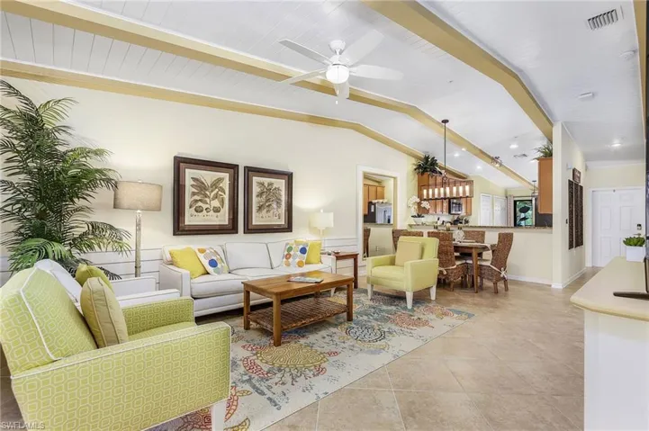 Living area with light tile patterned floors and ceiling fan