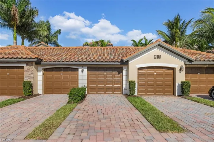 Mediterranean / spanish home featuring community garages, stucco siding, a tile roof, and stone siding