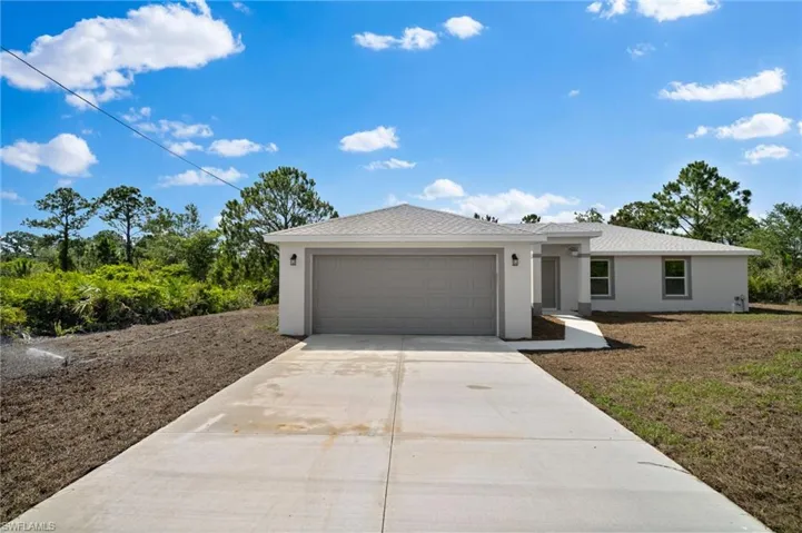 View of front facade with a garage and a front lawn