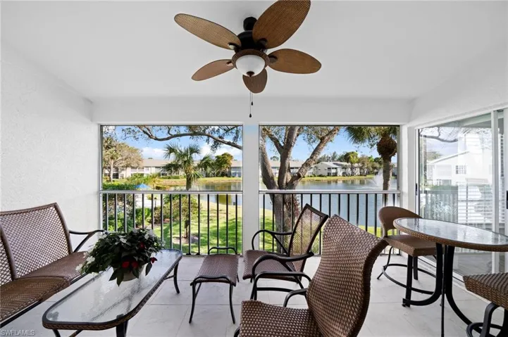 Sunroom featuring ceiling fan and a water view